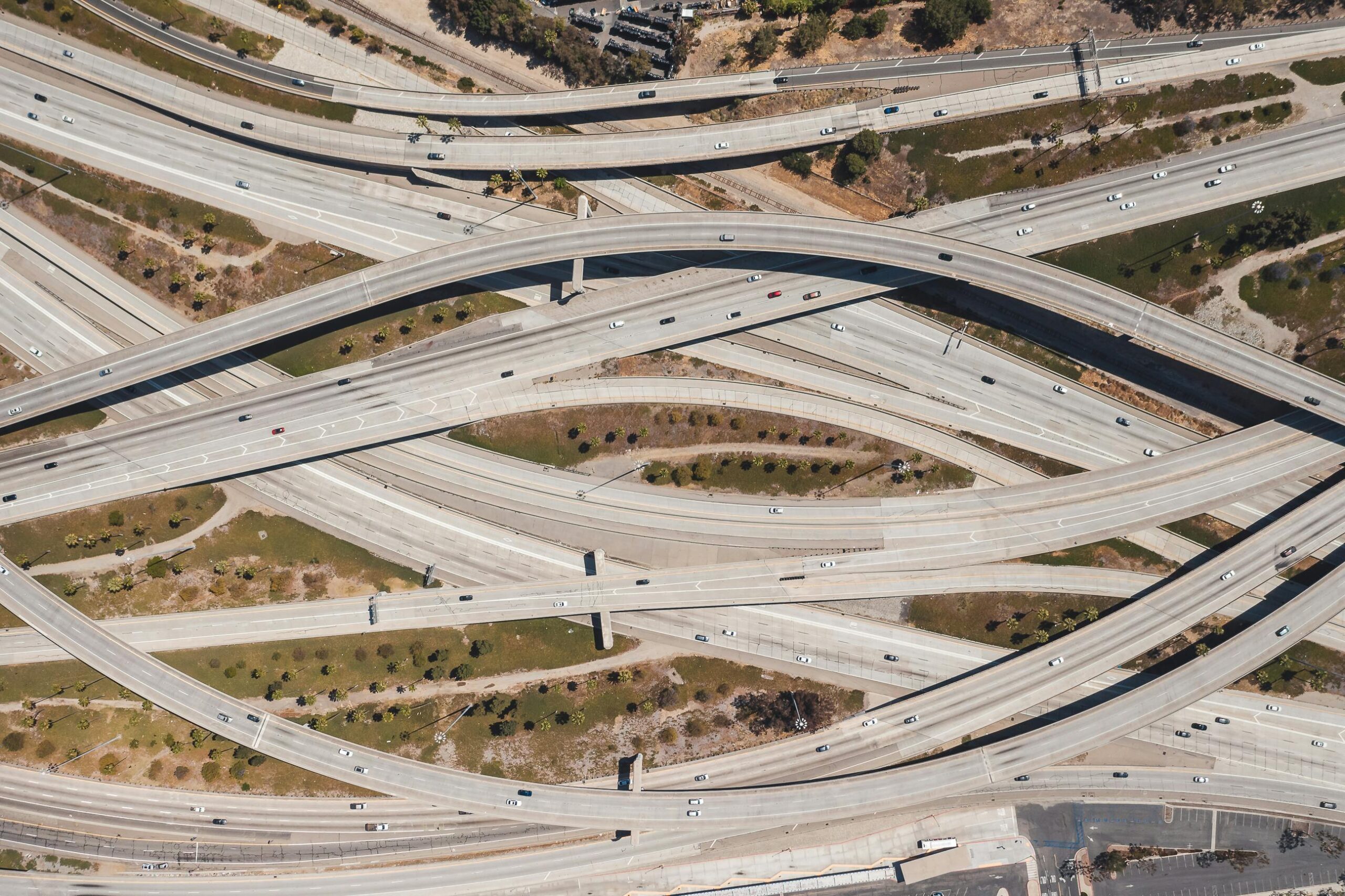 Aerial shot of sprawling highway interchange in Los Angeles with sparse traffic.